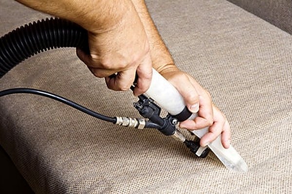 Upholstery extraction tool cleaning a family sofa in a Noblesville IN home